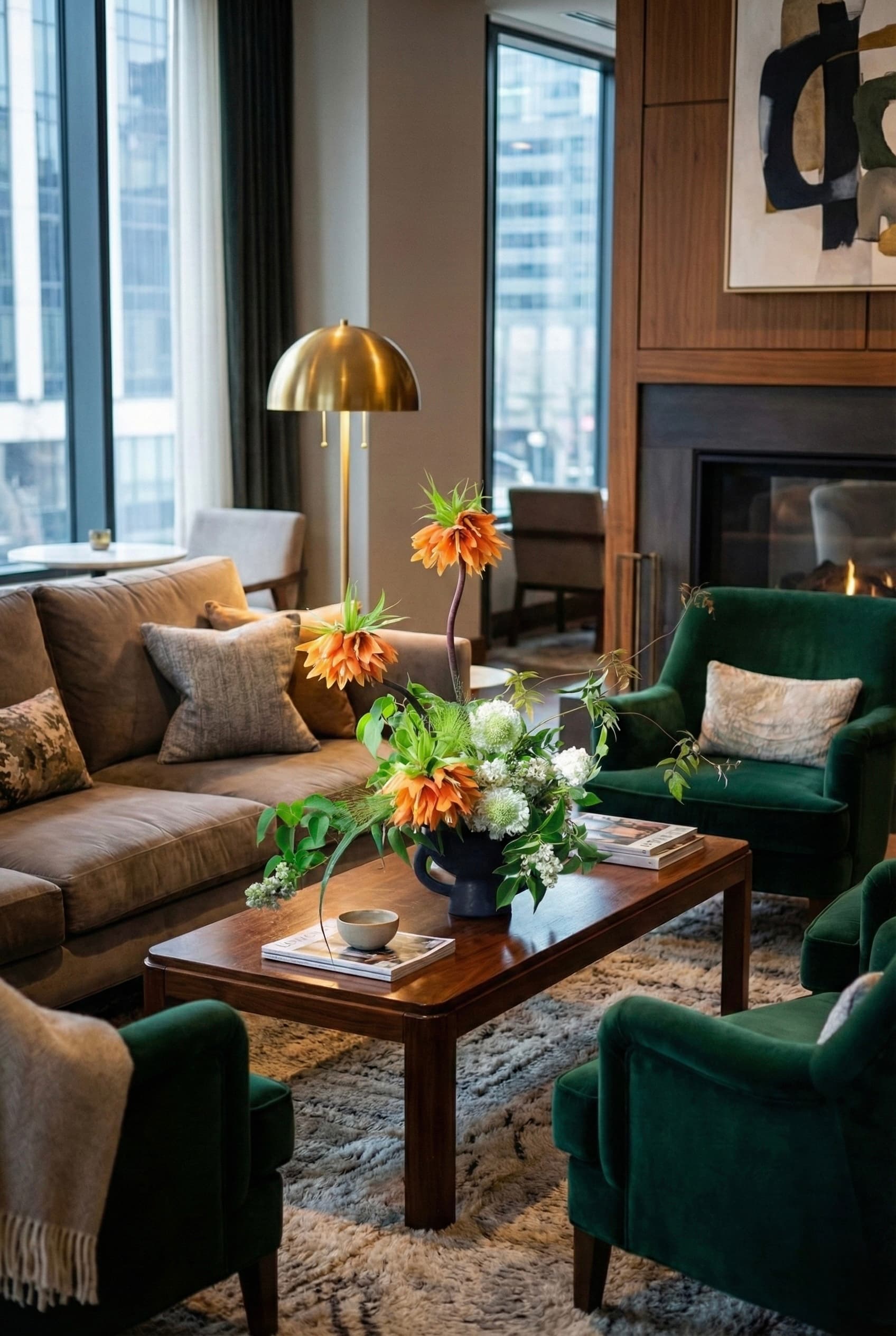 Living room with a brown sectional sofa, green armchairs, and a coffee table with flowers.