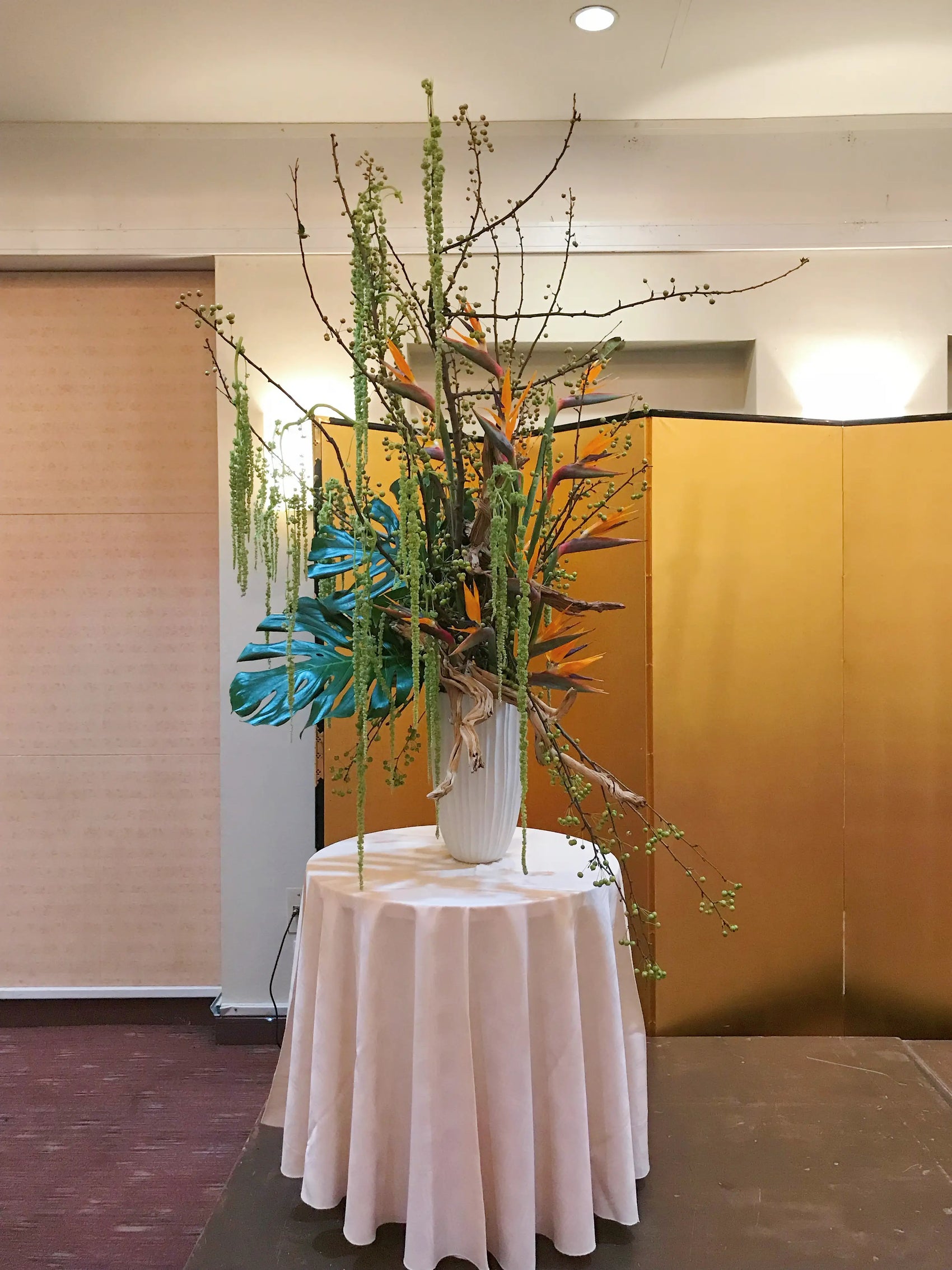 structural tropical flower arrangement for a bar