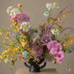 Fireworks flower arrangement with orchids and colorful wildflower-style seasonal blooms