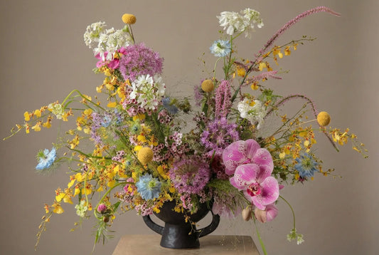 Fireworks flower arrangement with orchids and colorful wildflower-style seasonal blooms