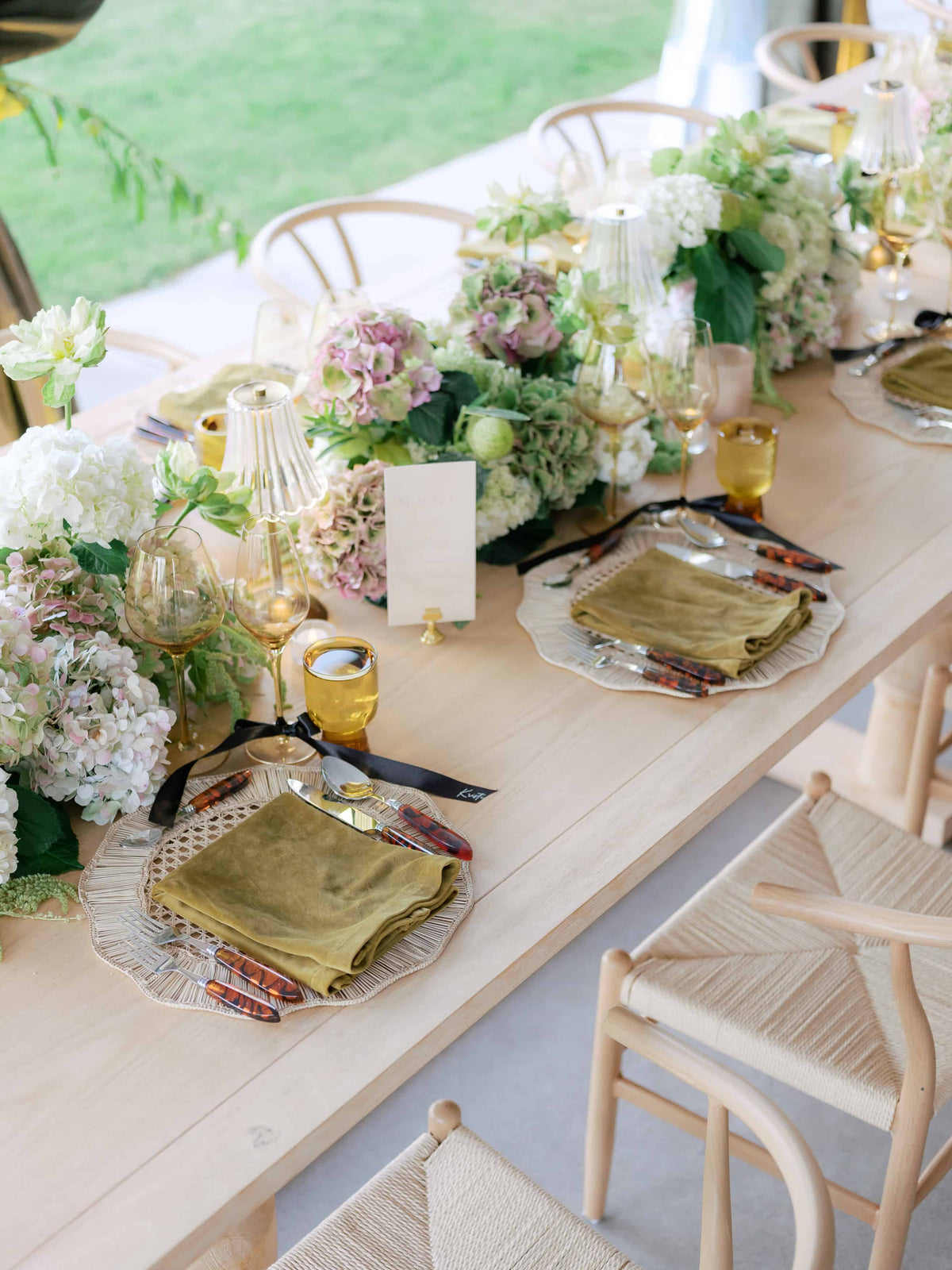 Elegant table setting with floral arrangements, green napkins, design by Colorado wedding florist shaa.Project
