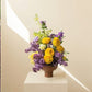 Fresh floral arrangement with yellow and purple flowers is a great gift Mother's Day
