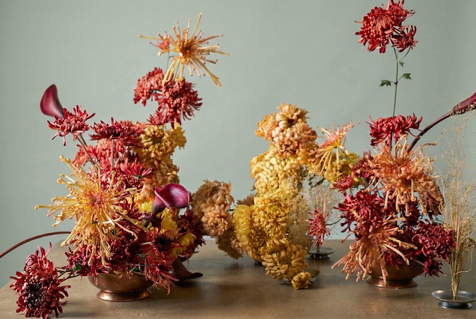 Artistic floral installation with chrysanthemum sculptures in copper vessels, part of a site-specific flower lab experiment by Shaa.Project.