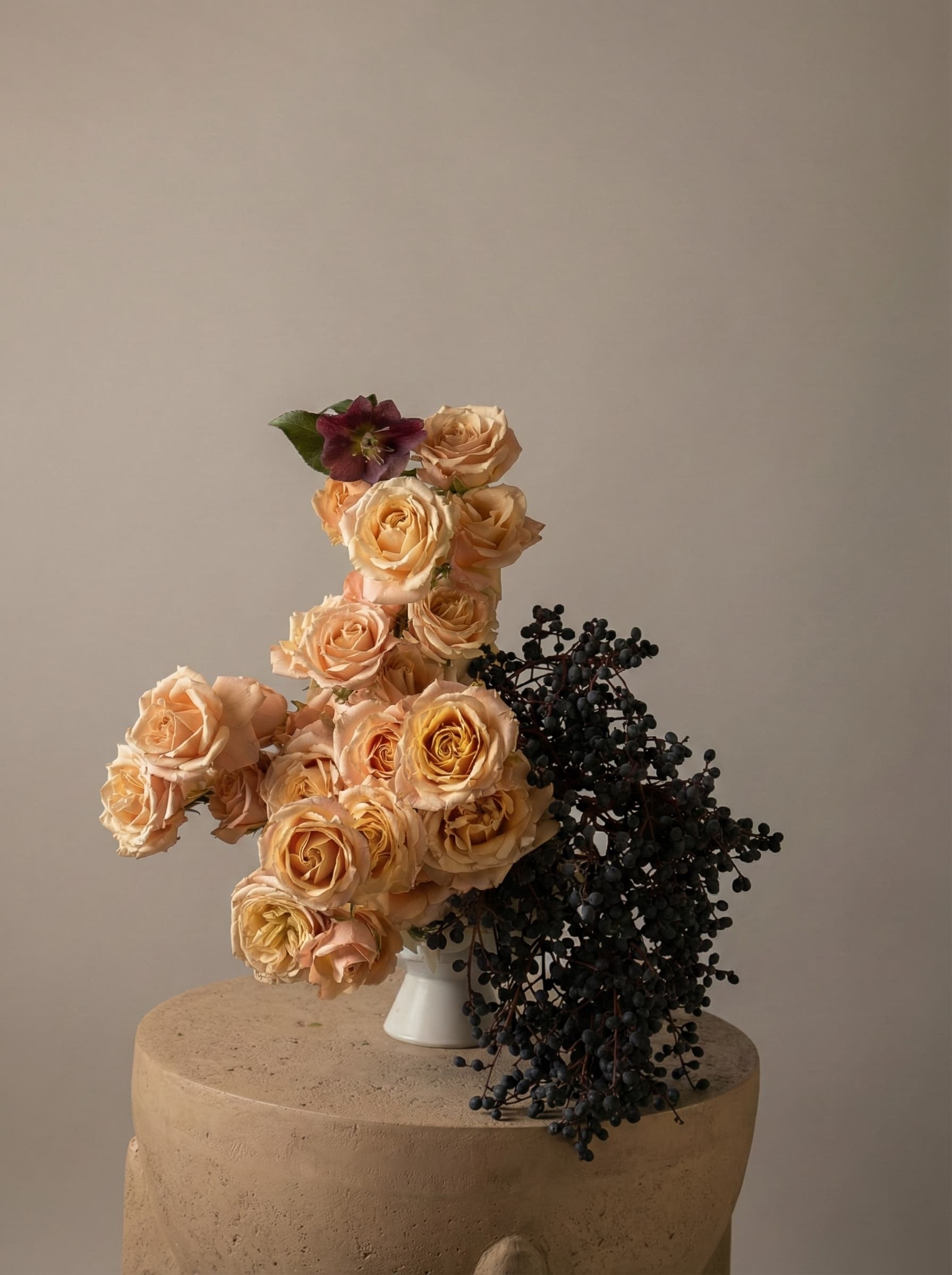 Peach Rose and black berry sculptural arrangement with a touch of hellebores by Shaa.Project