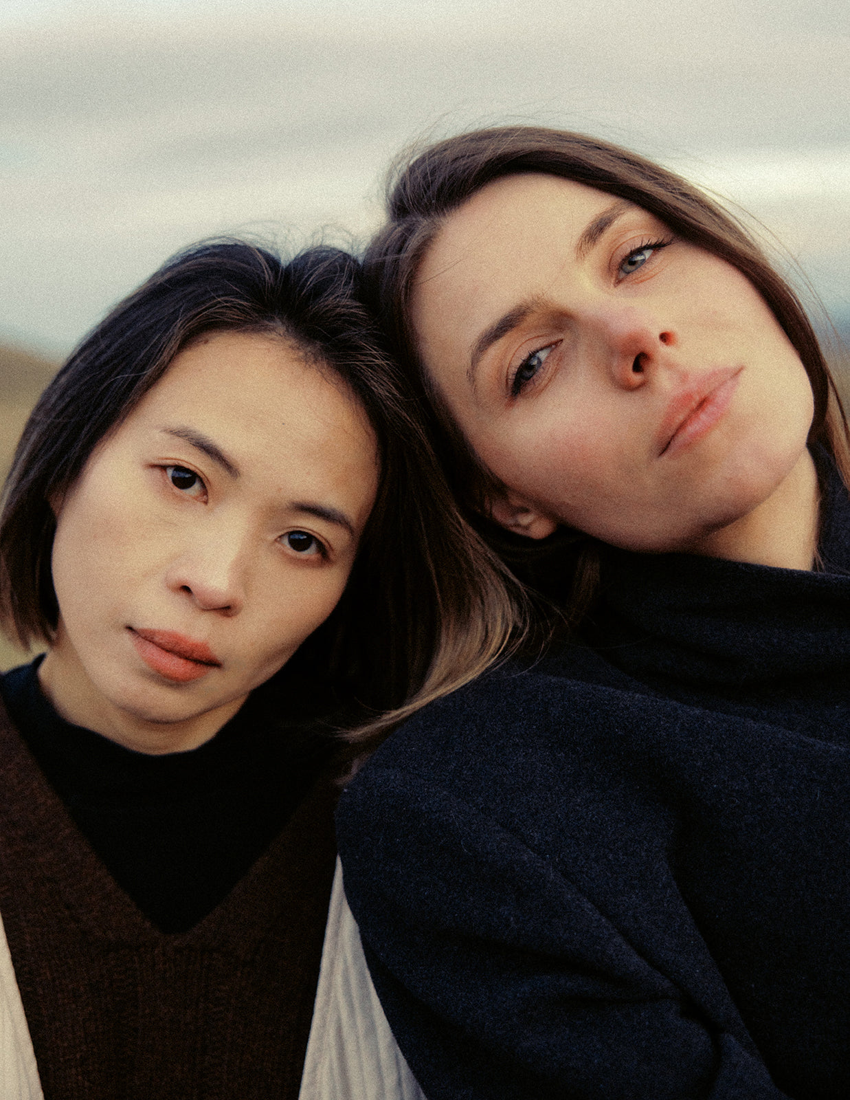 Two women posing closely together with a neutral background. Photoshoot for Skyler and Dasha. Shaa.Project