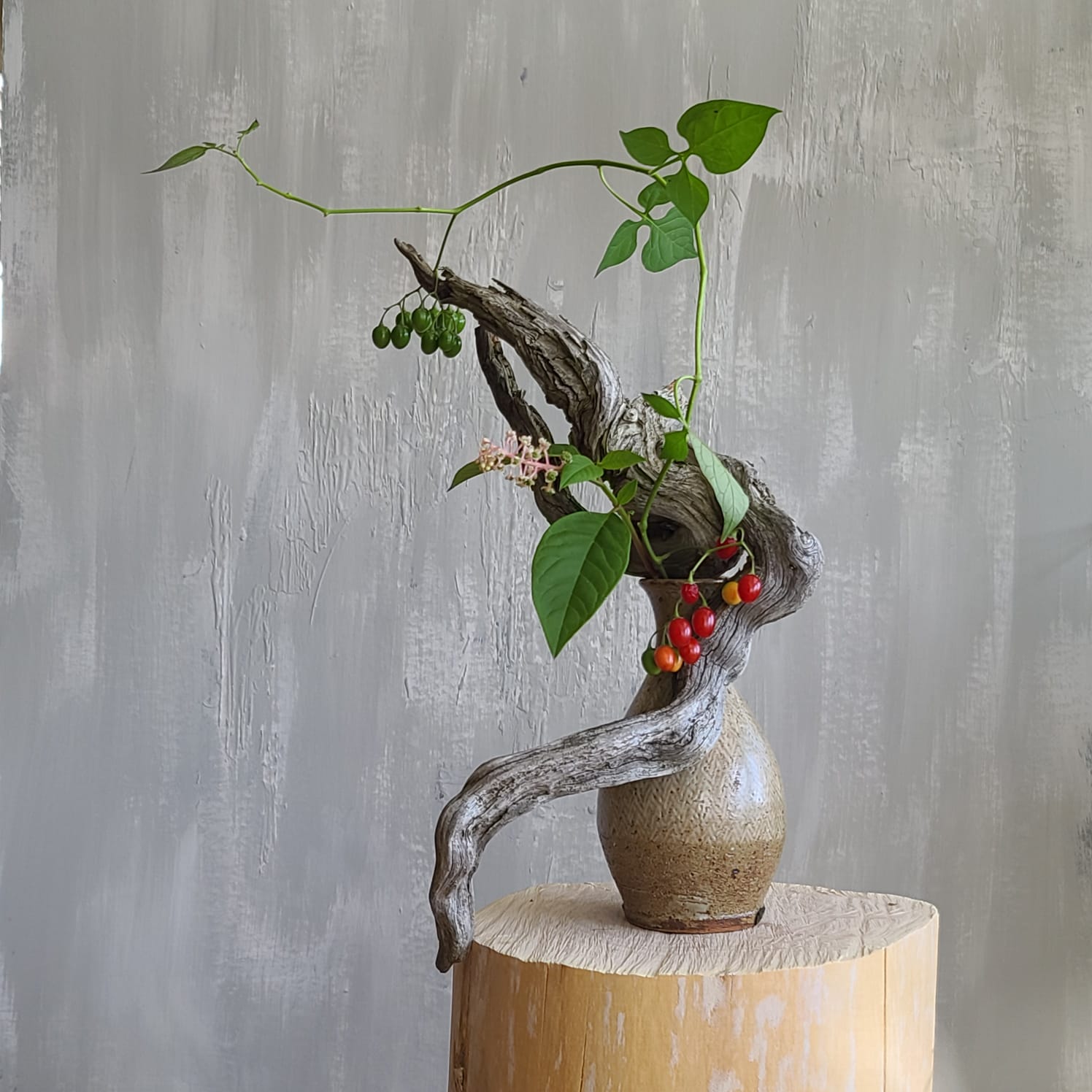 Ikebana inspired gray dried wood with berry vine