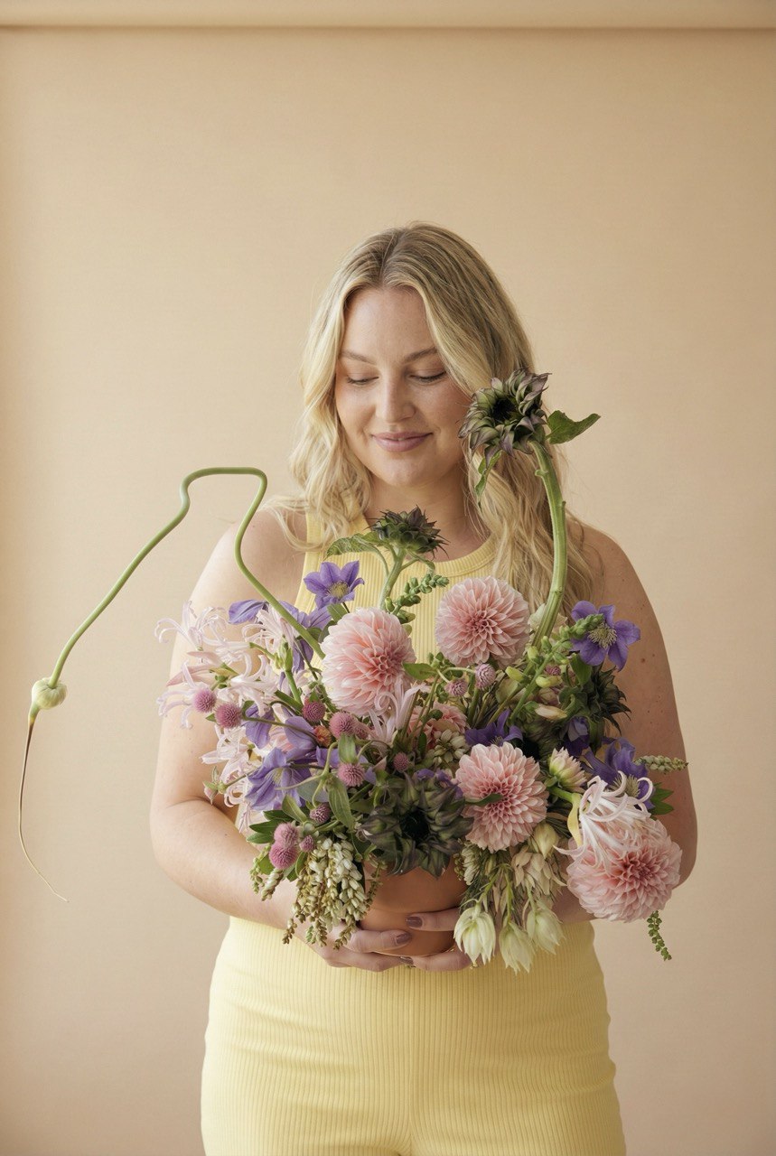 Curious Garden artistic flower arrangement with dahlias and sculptural stems