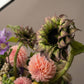 Close-up of Curious Garden floral design with pink dahlias and sculptural garden blooms