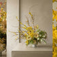 bright and yellow spring arrangement. Tulips, gerbera, blooming branches, orchid