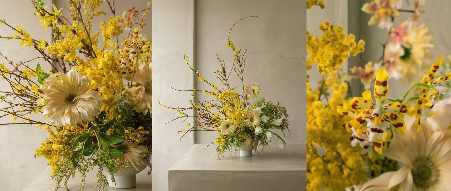 bright and yellow spring arrangement. Tulips, gerbera, blooming branches, orchid
