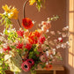 Colorful flower arrangement in a vase with poppies, orchids