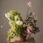 soft pastel sympathy flower arrangement with hydrangea, clematis, and seasonal blooms