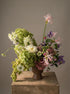 soft pastel sympathy flower arrangement with hydrangea, clematis, and seasonal blooms