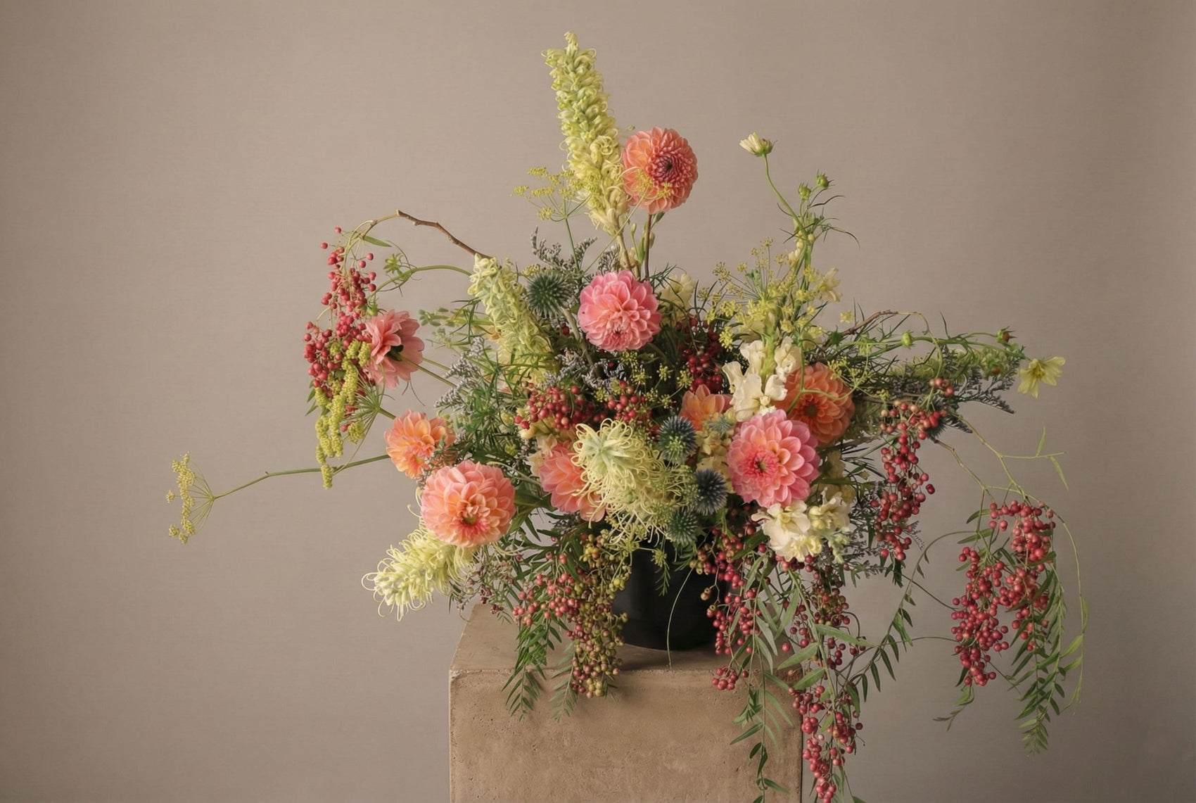 Coral Grove flower arrangement with coral dahlias, seasonal garden flowers, and cascading berries