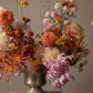 Garden-style seasonal flower arrangement with dahlias, chrysanthemums, and mixed blooms
