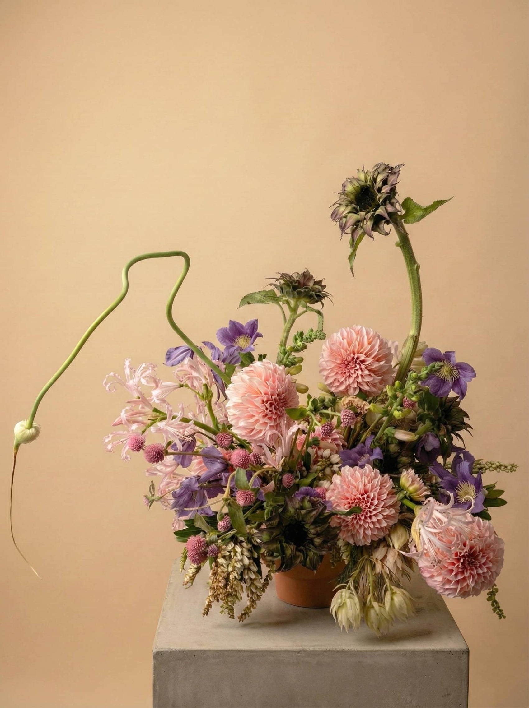 Seasonal designer’s choice flower arrangement with pink dahlias, clematis, and garden-style blooms