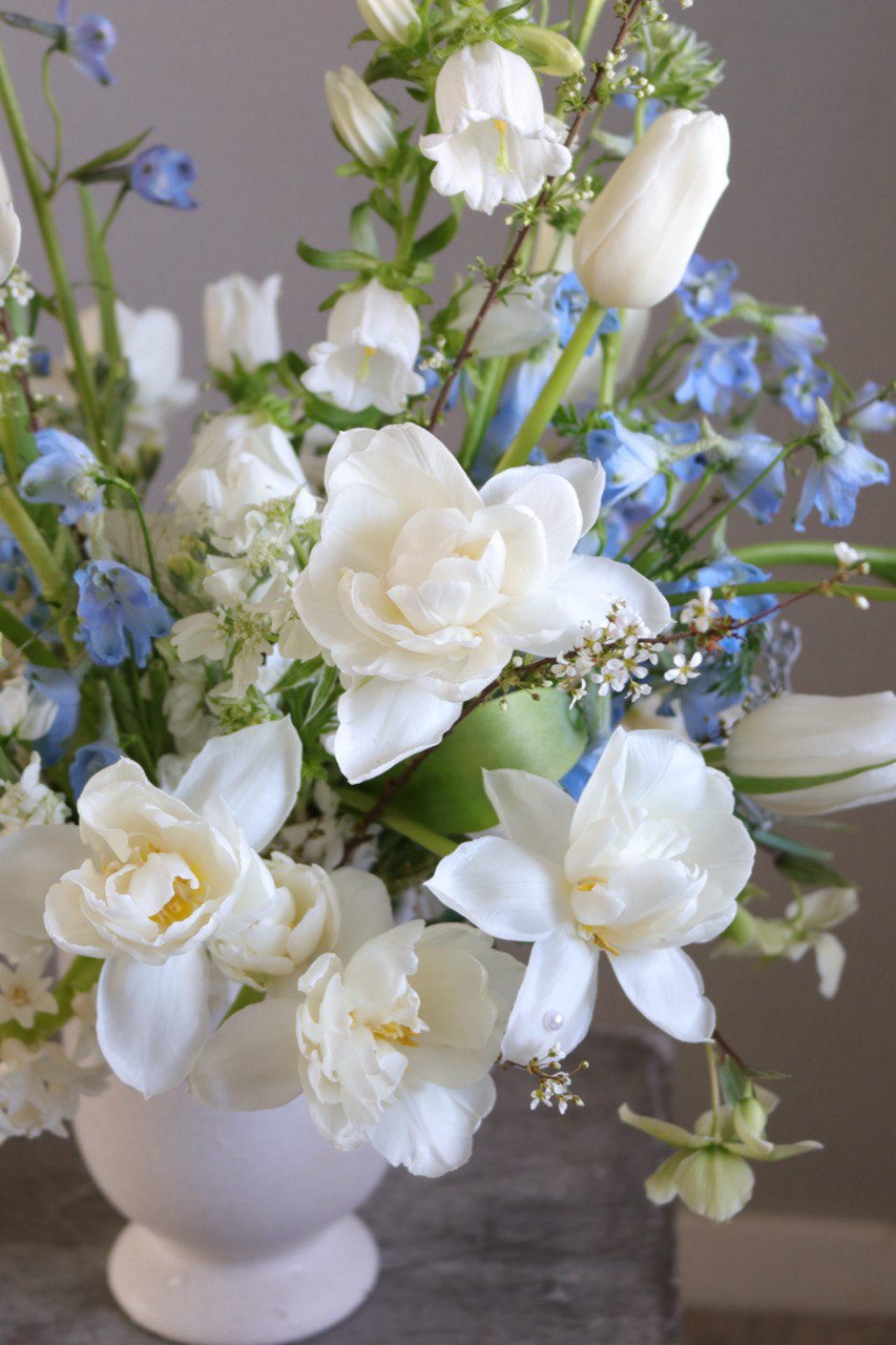 Close-up of Gentle Rise arrangement with white flowers and soft blue accents