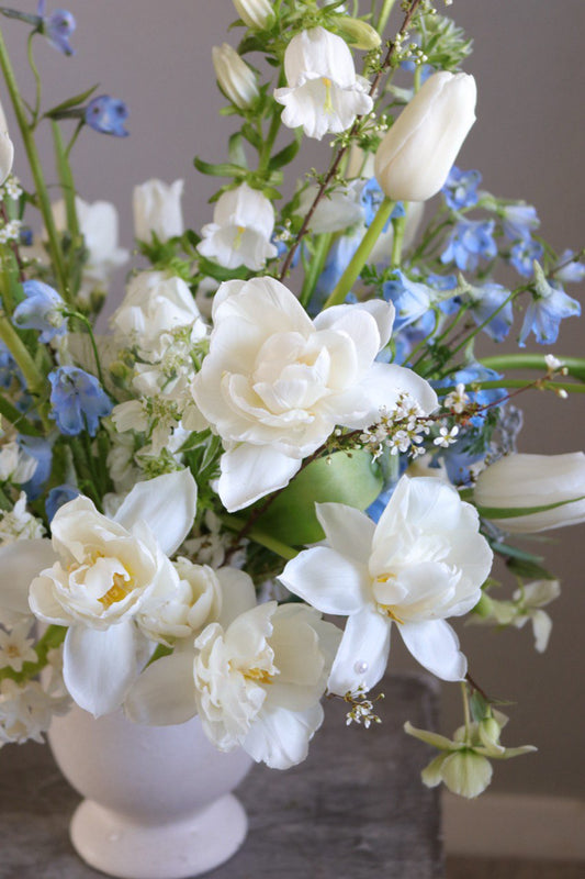 Close-up of Gentle Rise arrangement with white flowers and soft blue accents