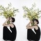 Olive minimalist green flower arrangement with sculptural stems and fresh greenery
