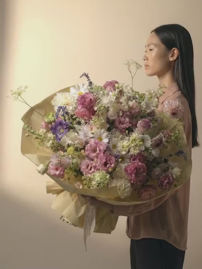 A big bouquet in soft pink, light purple, white and cream color blooms