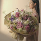 A big bouquet in soft pink, light purple, white and cream color blooms