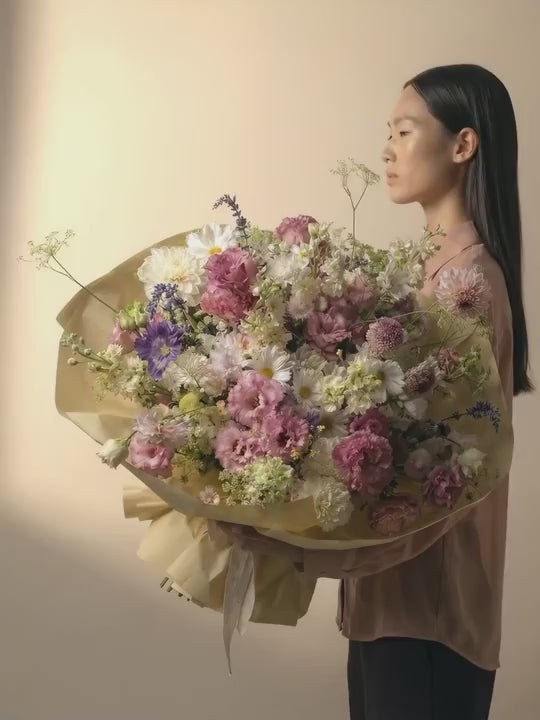 A big bouquet in soft pink, light purple, white and cream color blooms
