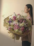 A big bouquet in soft pink, light purple, white and cream color blooms