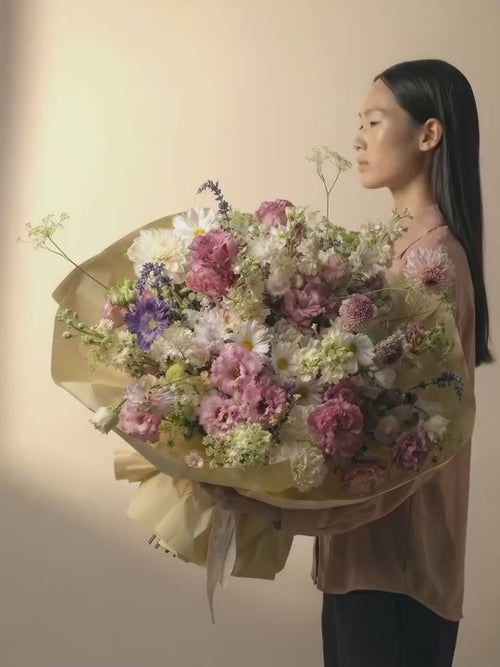 A big bouquet in soft pink, light purple, white and cream color blooms