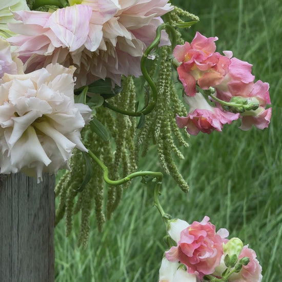 Romantic pink floral arrangement with dahlias and soft garden blooms