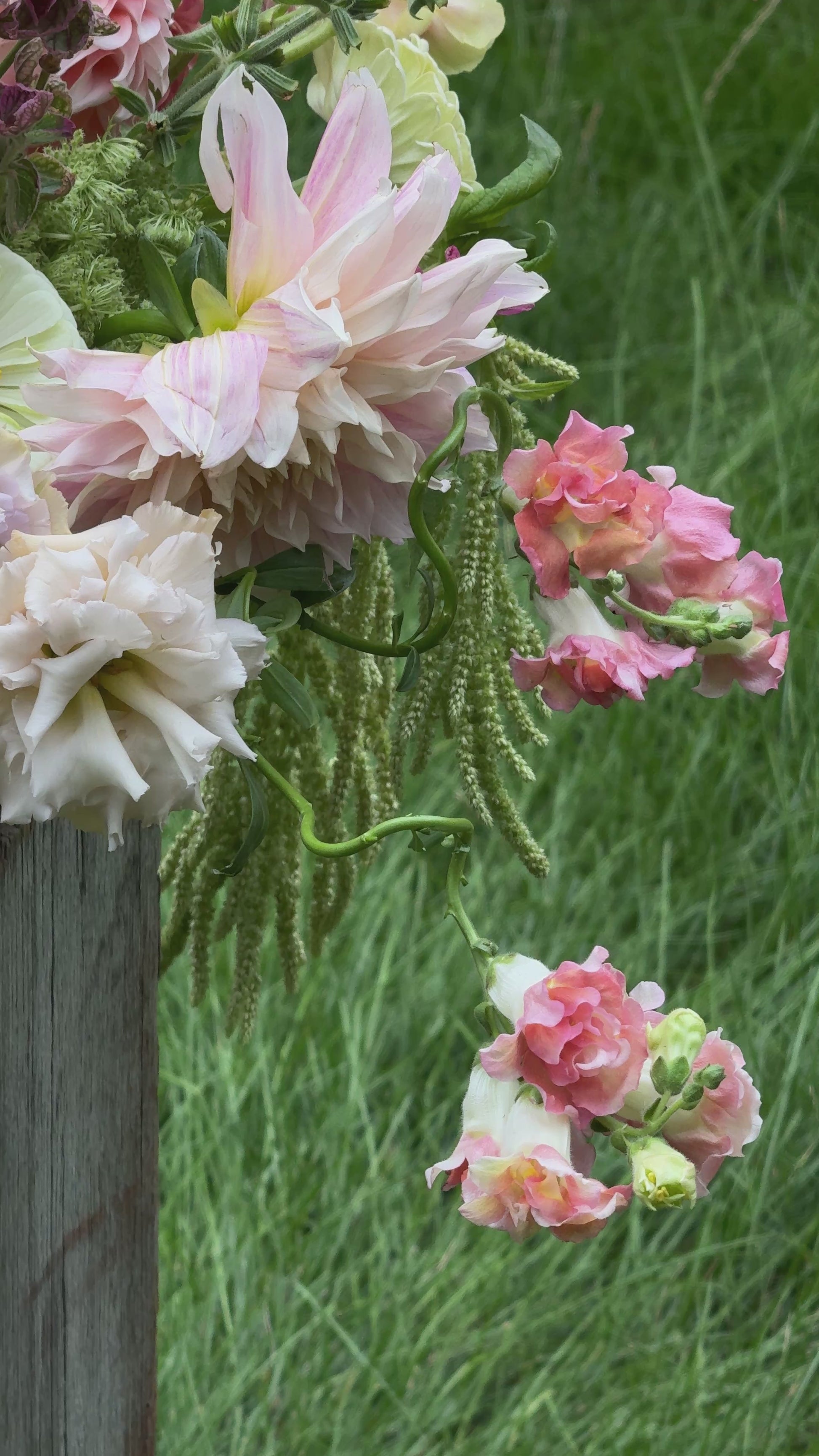 Romantic pink floral arrangement with dahlias and soft garden blooms