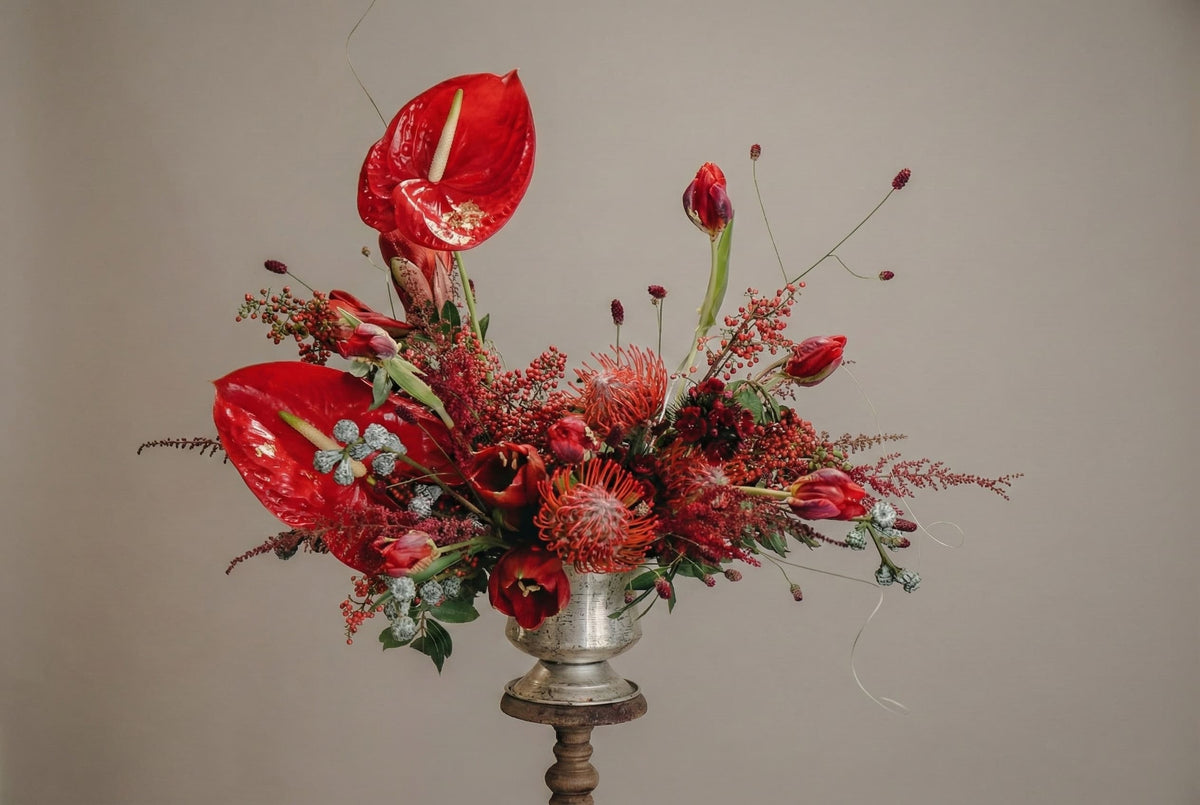 Modern floral arrangement with red anthurium, pincushion protea, and seasonal flowers by shaa.project