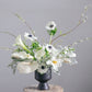 white sympathy flower arrangement with calla lilies, anemones, and delicate branches