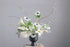 white sympathy flower arrangement with calla lilies, anemones, and delicate branches