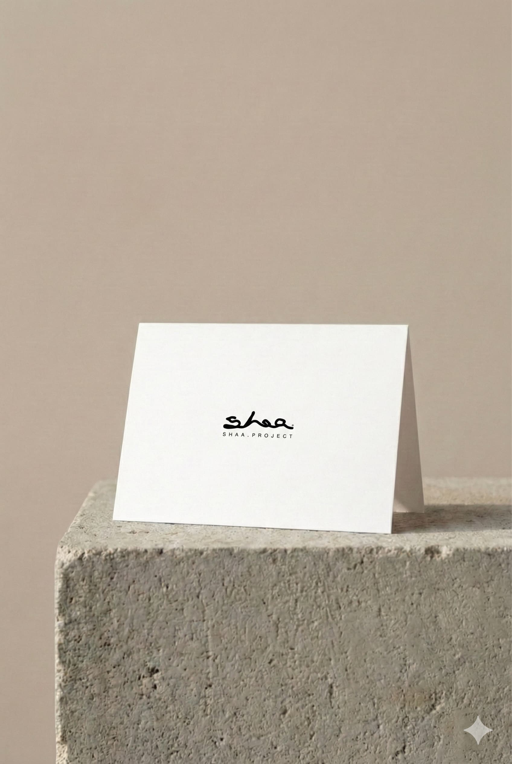 Shaa.Project simple message card displayed on stone pedestal