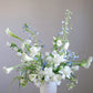 Shaa.Project Gentle Rise floral arrangement featuring sympathy flowers in soft colors, displayed in a serene setting.