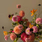 Sunburst colorful flower arrangement with dahlias and tulips in warm sunset tones