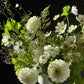 white sympathy flower arrangement with dahlias and cosmos in a ceramic vase