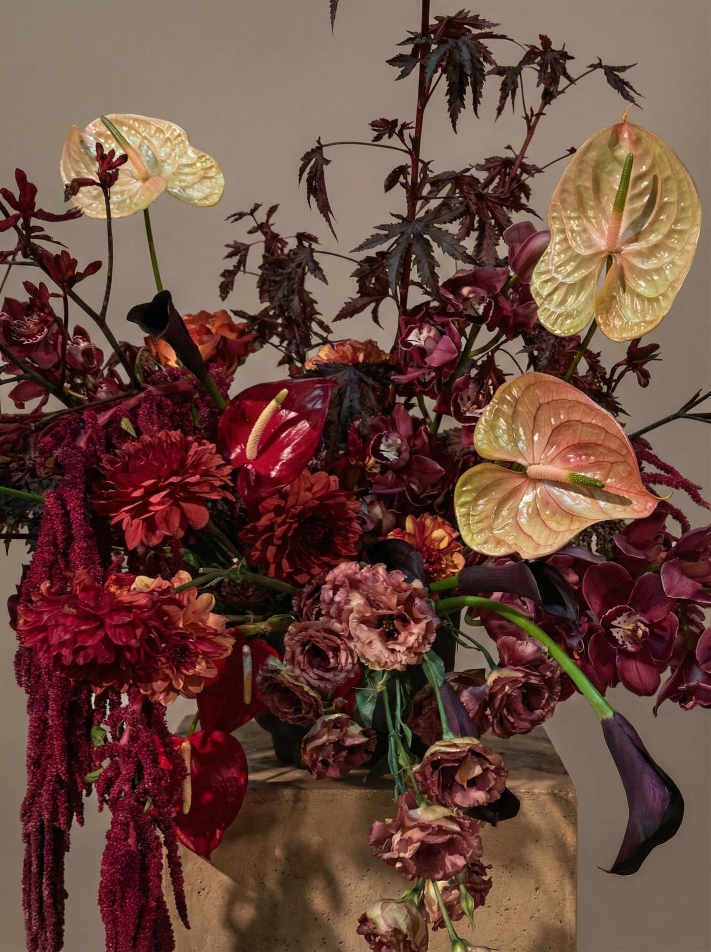 Moody burgundy floral arrangement with anthuriums and seasonal flowers from Shaa.Project flower subscription