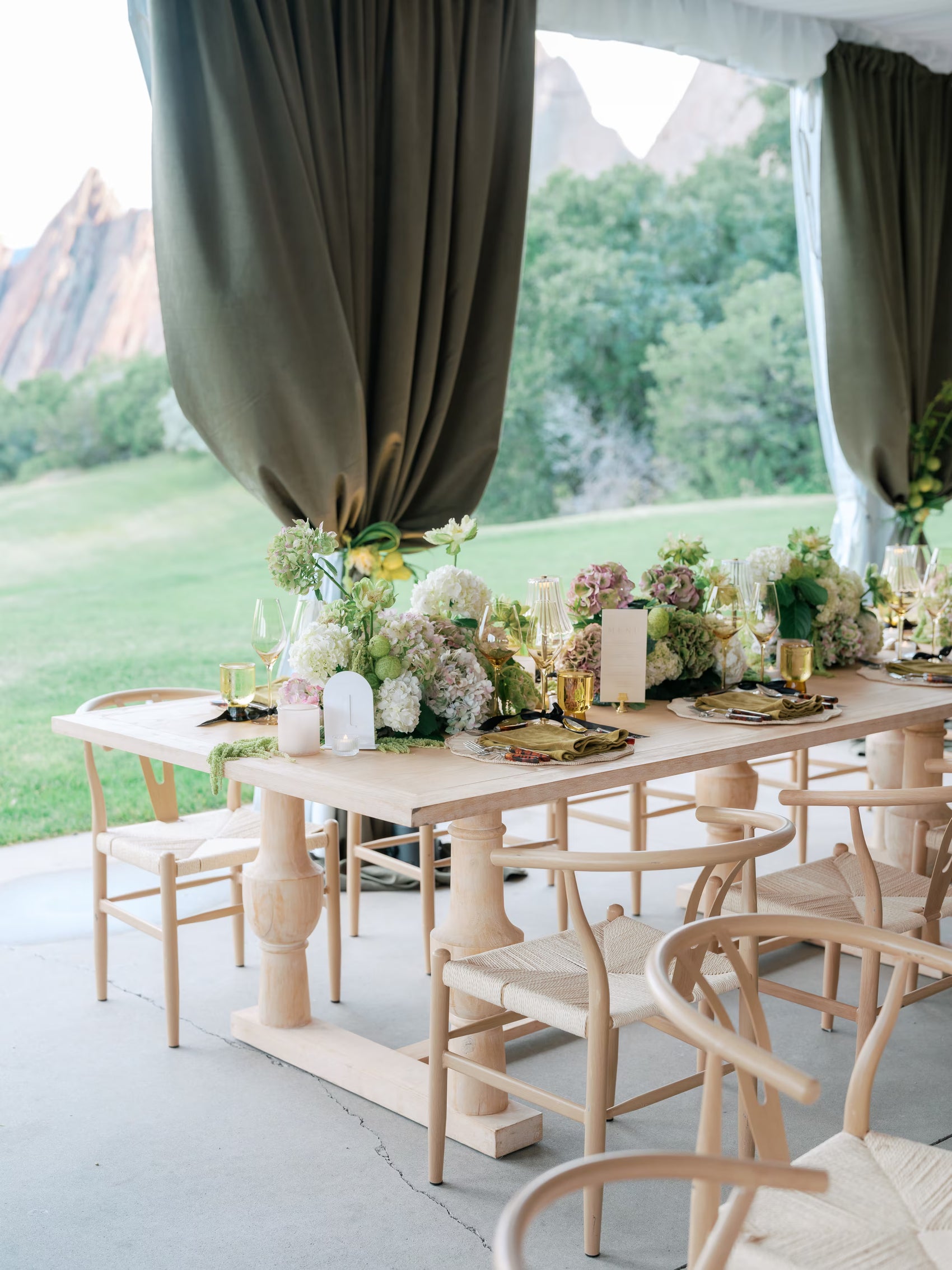 Modern wedding reception table with sculptural floral centerpieces and soft green hydrangea in Colorado