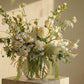 Airy white birthday flower arrangement with dahlias, orchids, and fresh greenery