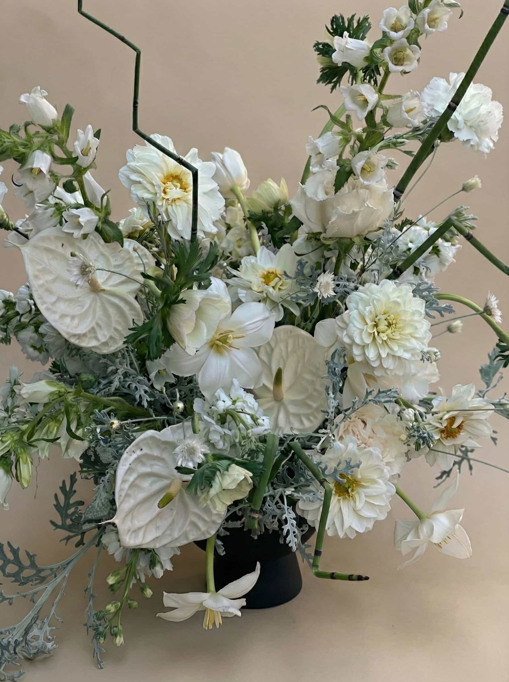 Stillness white flower arrangement with anthurium, dahlias, and layered seasonal blooms