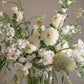Wishing white flower arrangement with dahlias, orchids, and airy seasonal blooms in a glass vase